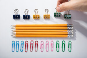 person's,finger,arranging,the,pencils,with,row,of,pins,rubber