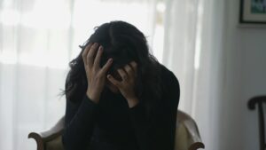 This picture shows a woman feeling shamed and having negative self-belief.
